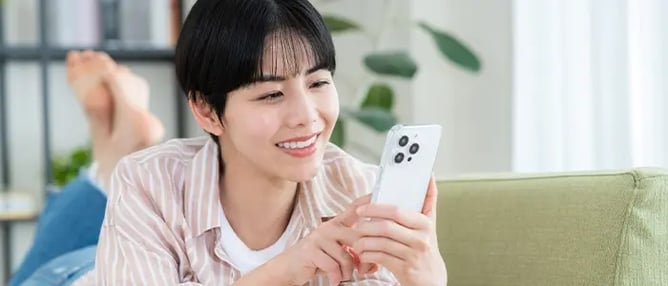 自宅でSNSで情報収集をする女性